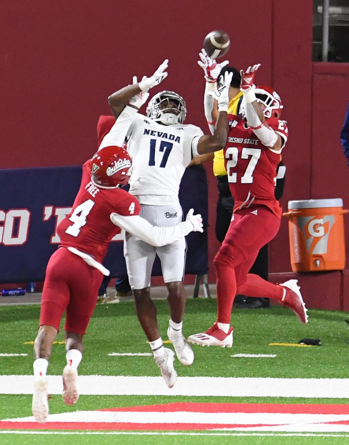 Fresno State’s Wylan Free, left, and LJ Early, right, break up a pass in the end zone to Nevada’s Justin Lockhart during their game at Bulldog Stadium on Saturday, Oct. 23, 2021.