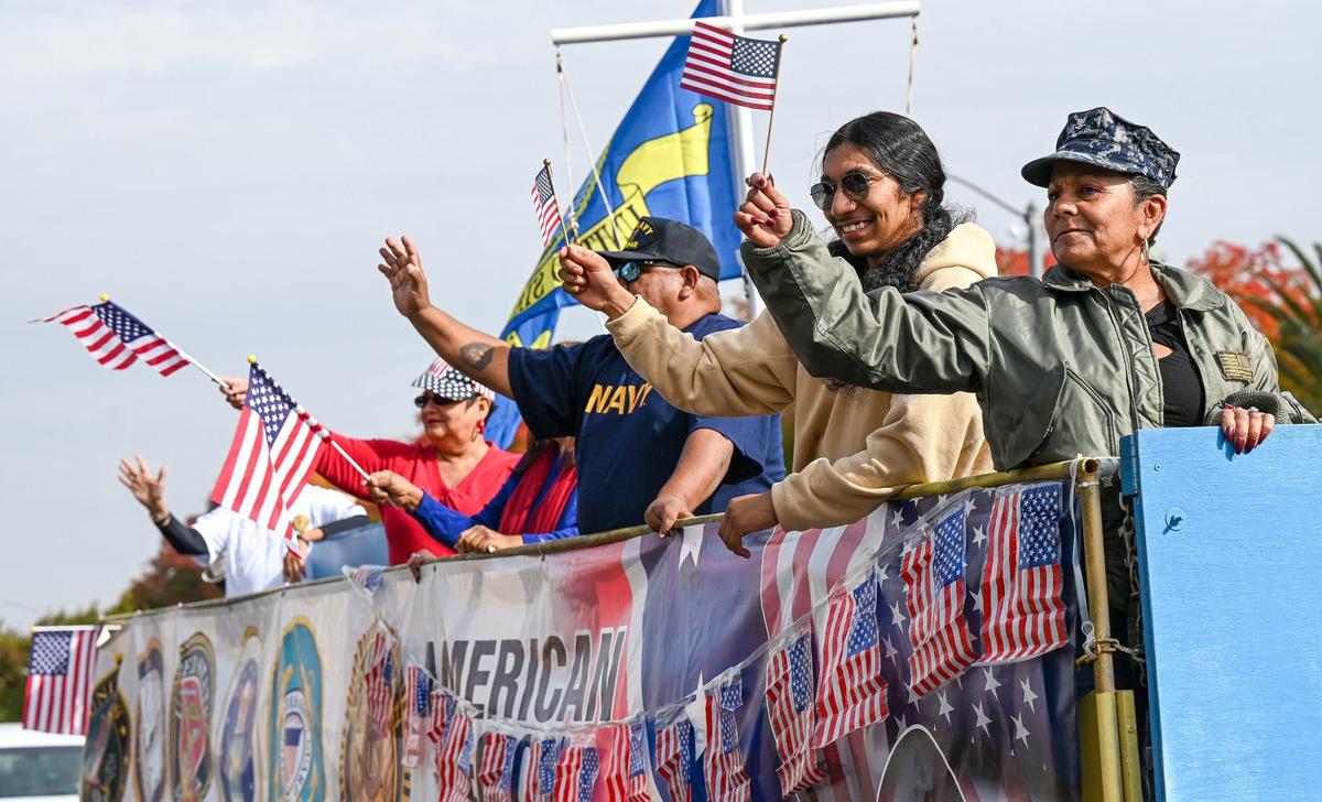 Veterans and their families wave from an American Legion Post 509 float during the 105th annual Central Valley Veterans Day Parade in downtown Fresno on Monday, Nov. 11, 2024.