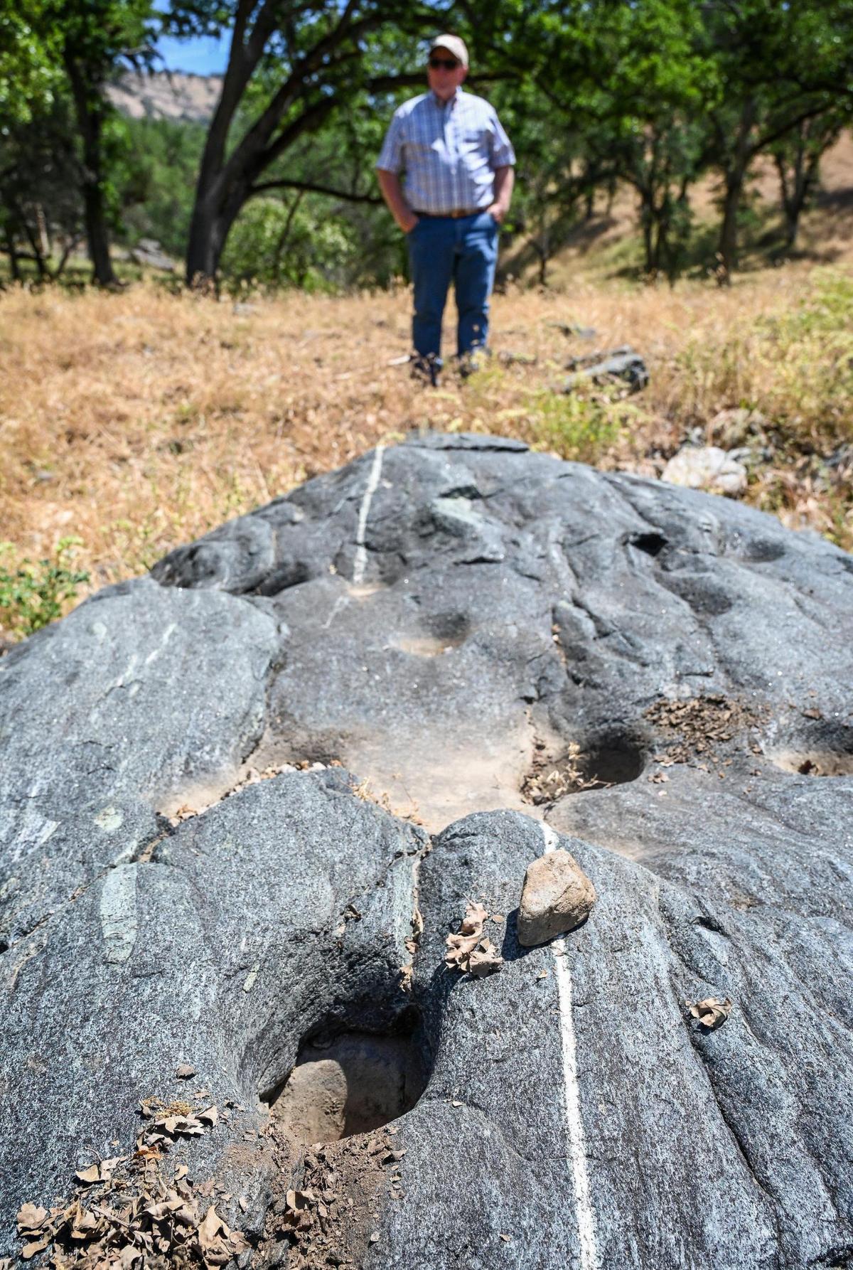 Michael Wright surveys the area near old Indian mortar holes on his Wright Ranch off Road 600 in Madera County on Wednesday, May 27, 2022. The Wright Ranch was recently acquired as a conservation easement by the Sierra Foothill Conservancy.