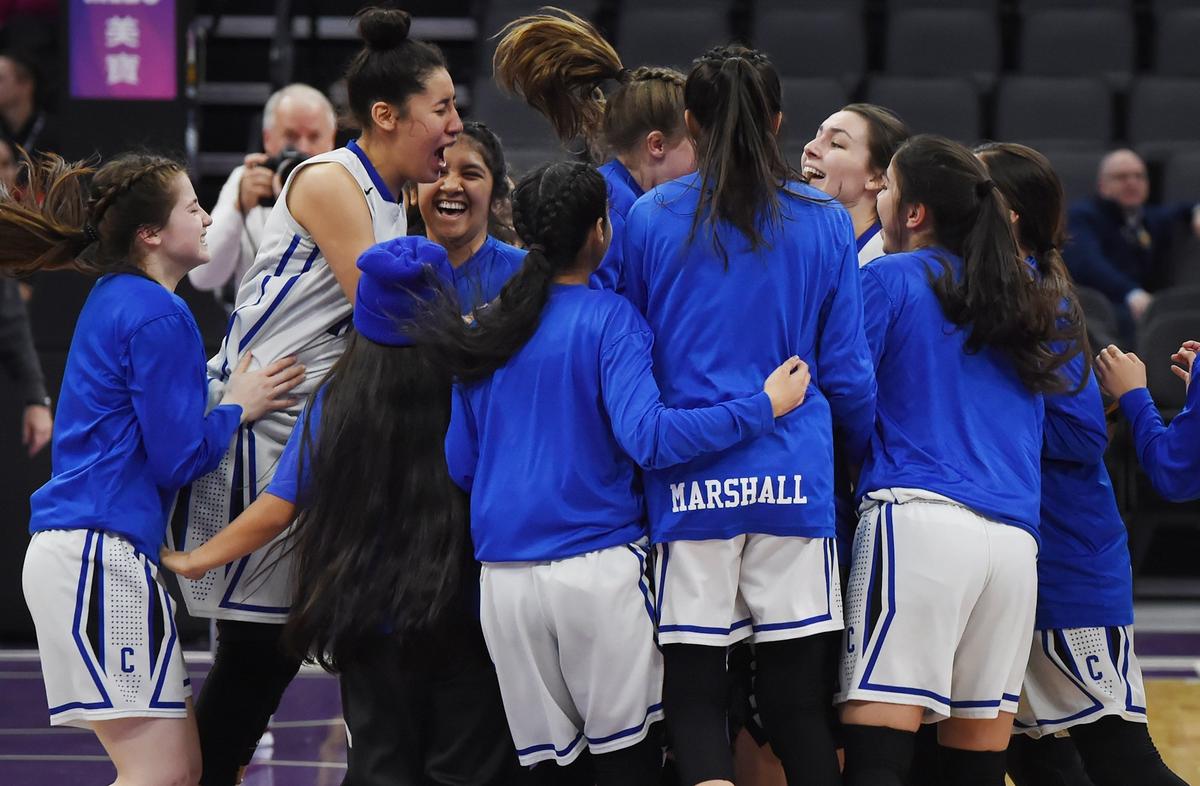 The Caruthers girls basketball team celebrates its 62-38 win against Ramona-Riverside at the CIF state girls DV basketball championship Friday, March 7, 2019 in Sacramento.