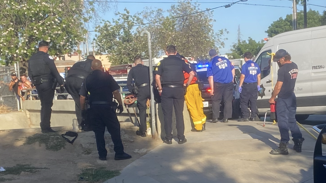Fresno police officers Fresno Fire Department crews work to bring a suspect to safety at Van Ness and Belmont avenues in Fresno, California on Saturday, June 14, 2025.