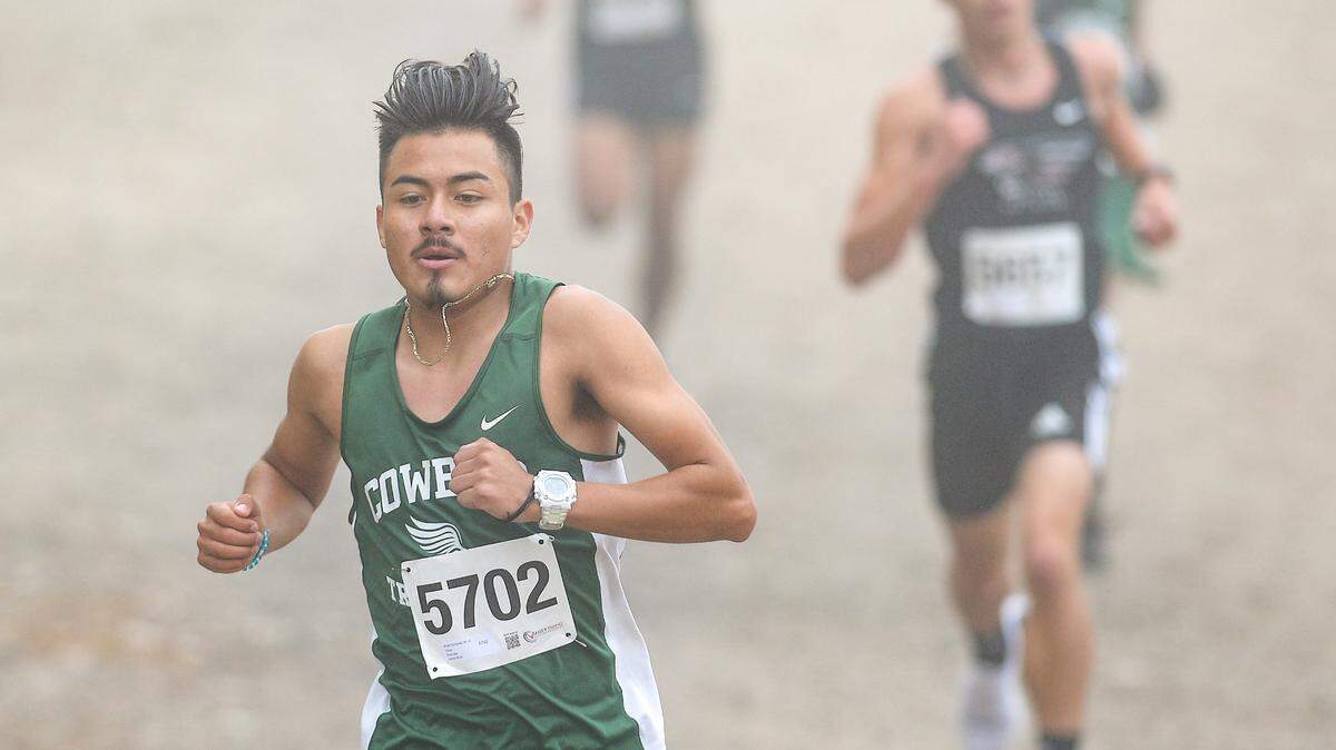 Bryan Gonzalez of Riverdale High School approaches the 2-mile marker during the West Sequoia League boys cross country race at Woodward Park in Fresno on Wednesday, Nov. 10, 2021. Gonzalez finished third in the race. Fall sports have carried on despite generally poor to bad air quality in the Fresno region.