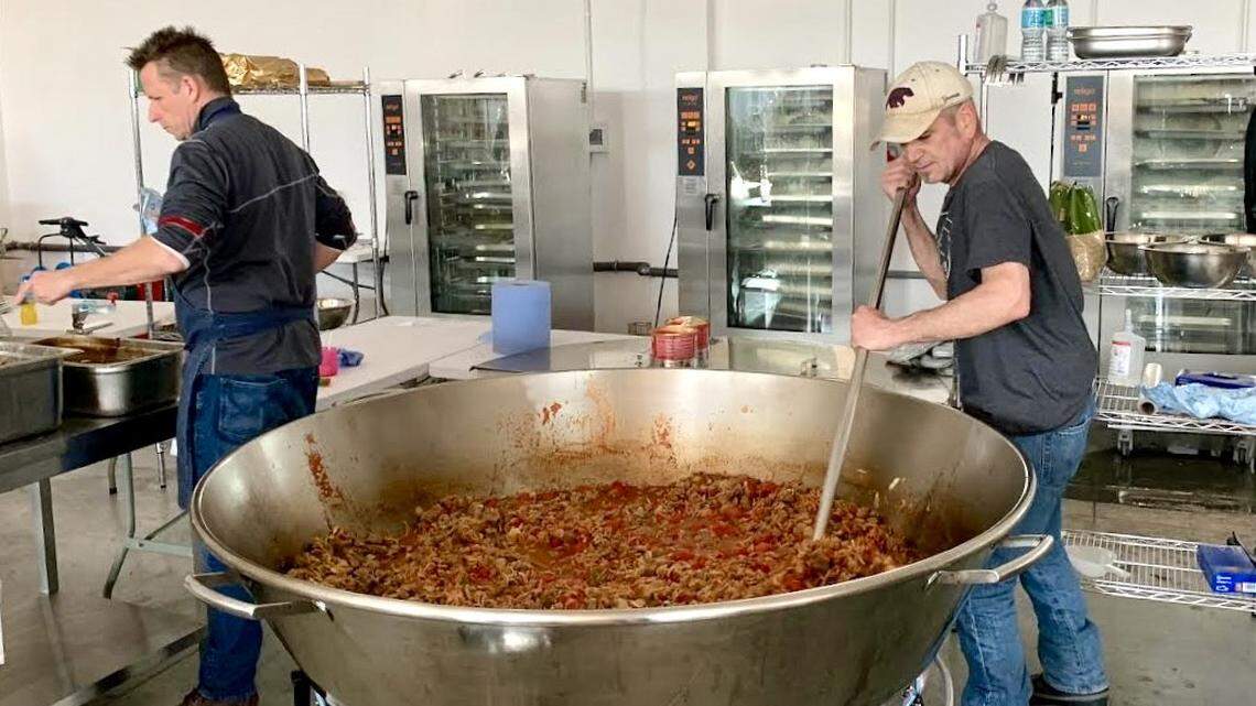 Warren McClain, right, cooking soup in March 2022 at a World Central Kitchen location in Poland, set up to feed Ukrainian refugees.