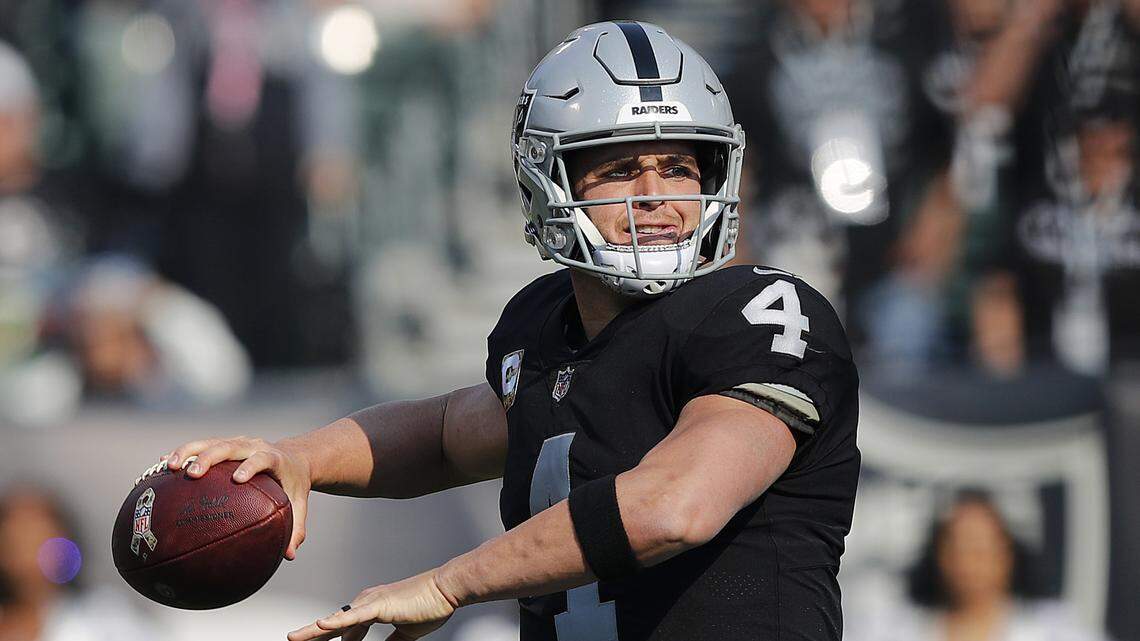 Oakland Raiders quarterback Derek Carr (4) passes against the Los Angeles Chargers during the first half of an NFL football game in Oakland, Calif., Sunday, Nov. 11, 2018. (AP Photo/John Hefti)