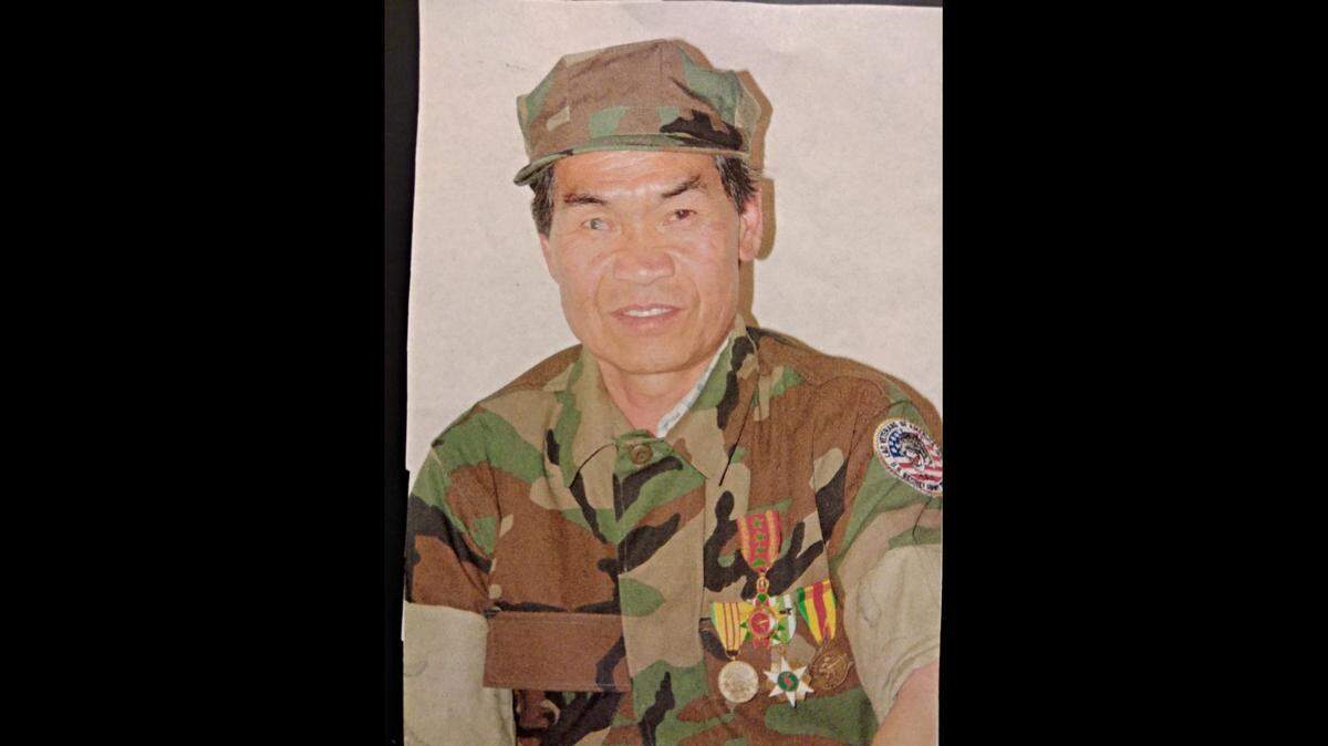 Yong, the Hmong man who lost his hearing after an attack by bees, but later learned sign language and became skilled at making silver jewelry. Here is he wearing his American Lao uniform.