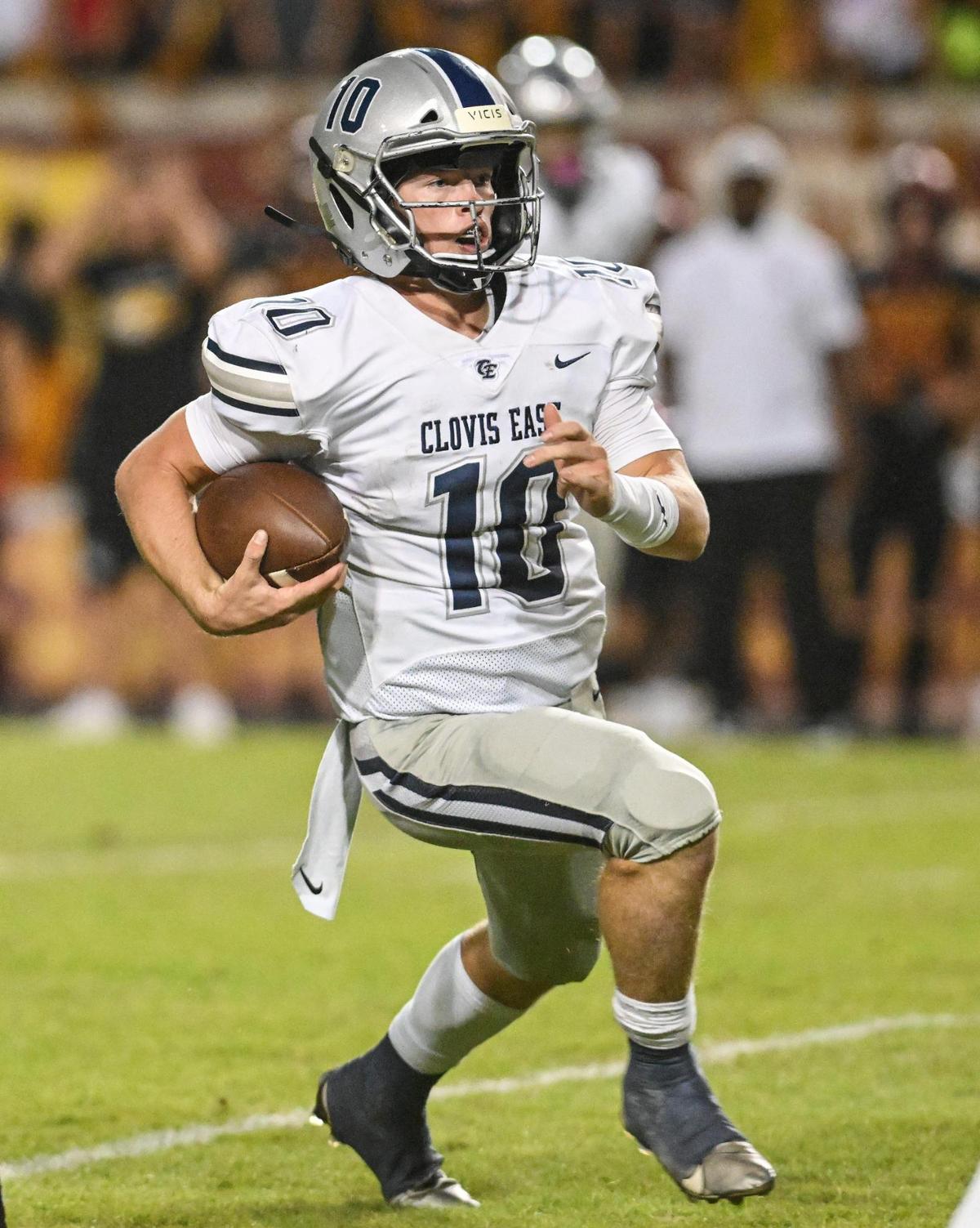 Clovis East quarterback Ty Miller takes the ball on a keeper against Clovis West during their game at Veterans Memorial Stadium in Clovis on Friday, Oct. 6, 2023.