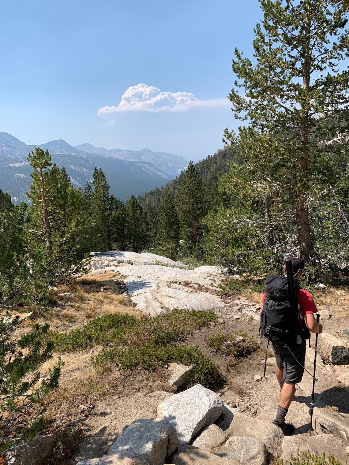 Brent McNelis hiking back down from Evolution Lake after seeing the Creek Fire, visible in the distance.