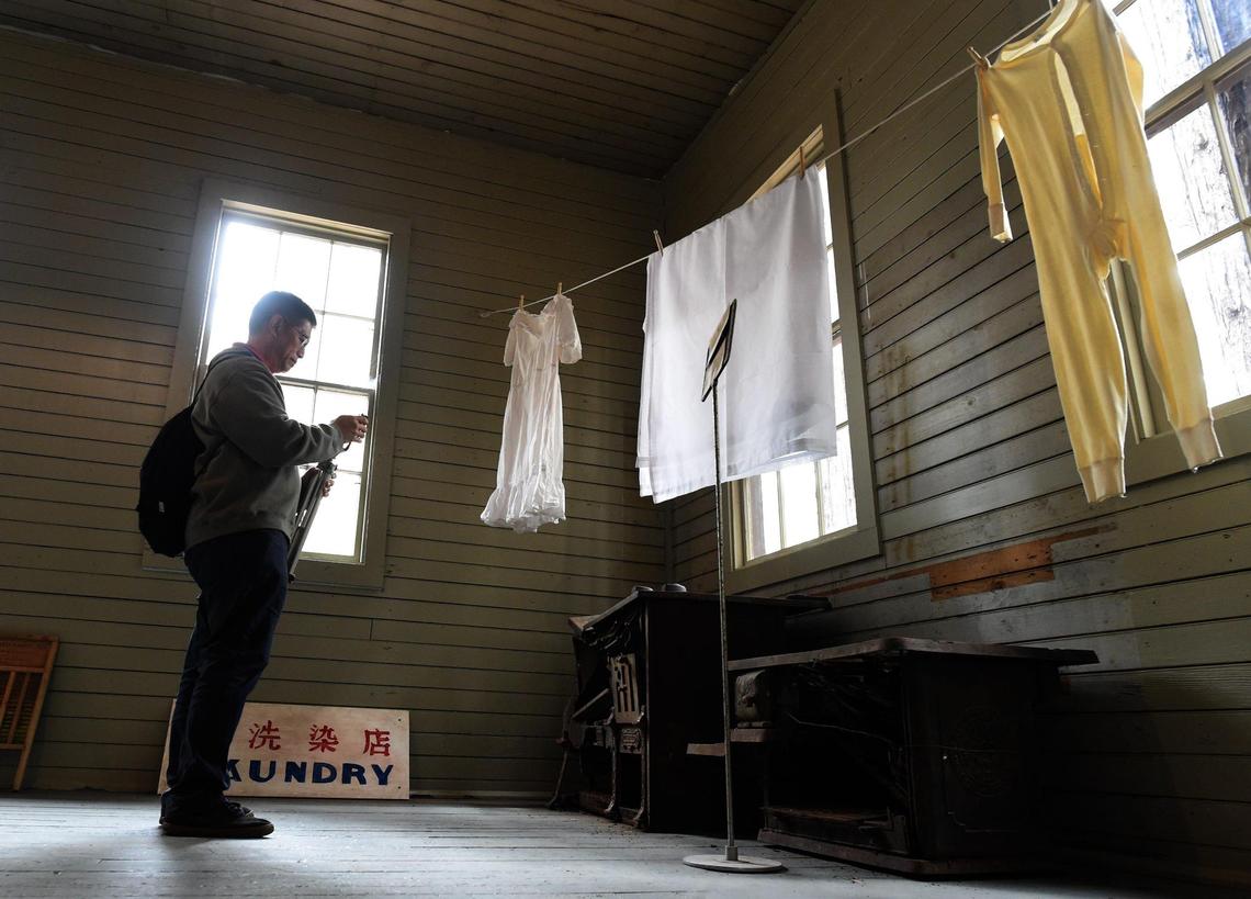 Ricky Leo of Thousand Oaks takes a photo of old stoves in the restored 1917 Chinese laundry building at Wawona, which was dedicated Friday, Oct. 1, 2021. The wood-burning stoves, were found in a pile of rubble outside the building, and will be restored.
