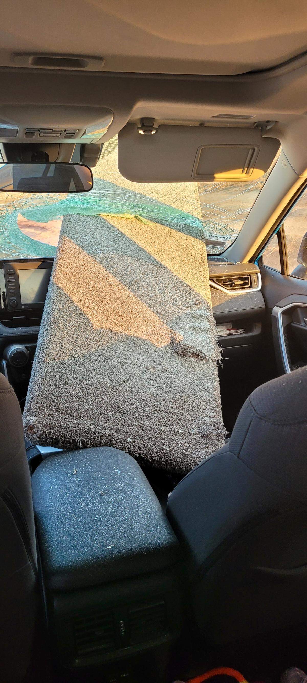 A carpeted wood plank smashed a hole through the windshield of an SUV while it was traveling on Highway 145 near Madera.