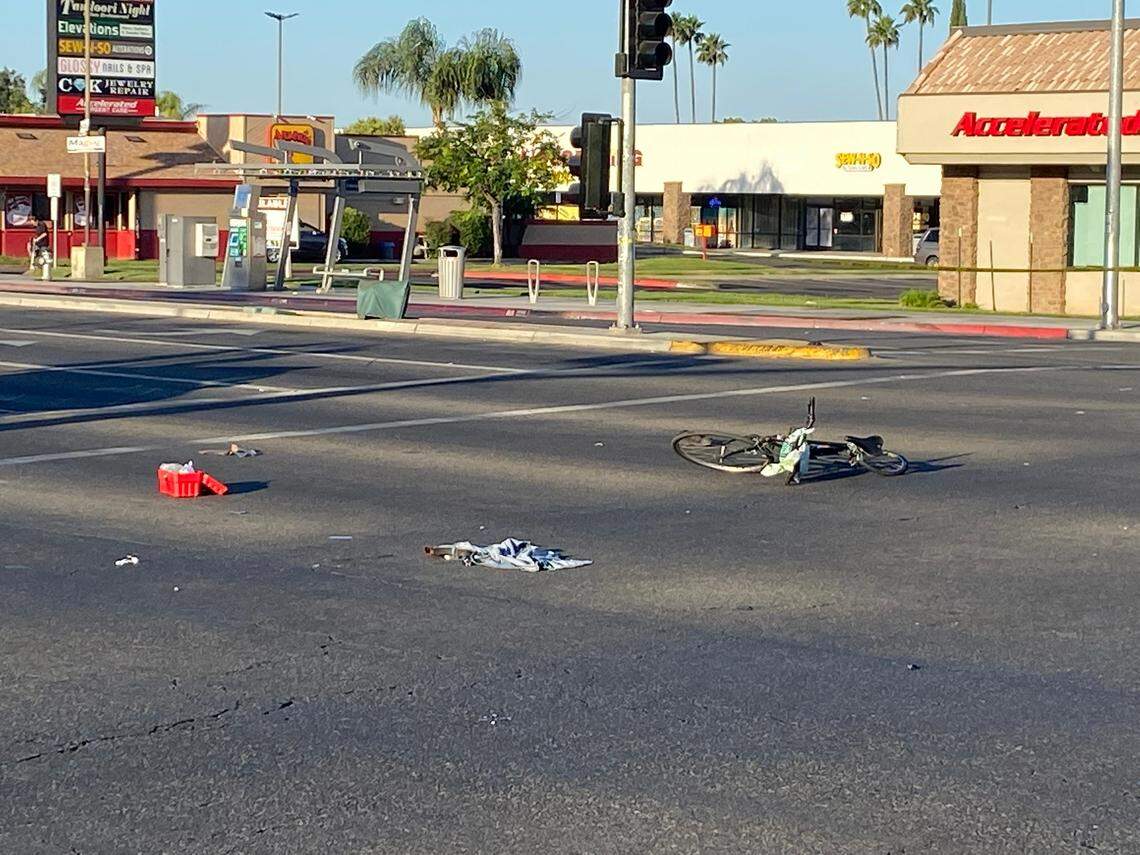 Fresno Police block off a portion of the intersection at Blackstone and Herndon avenues Tuesday morning, May 24, 2022, after a fatal bicycle collision. The bike remains in the roadway.