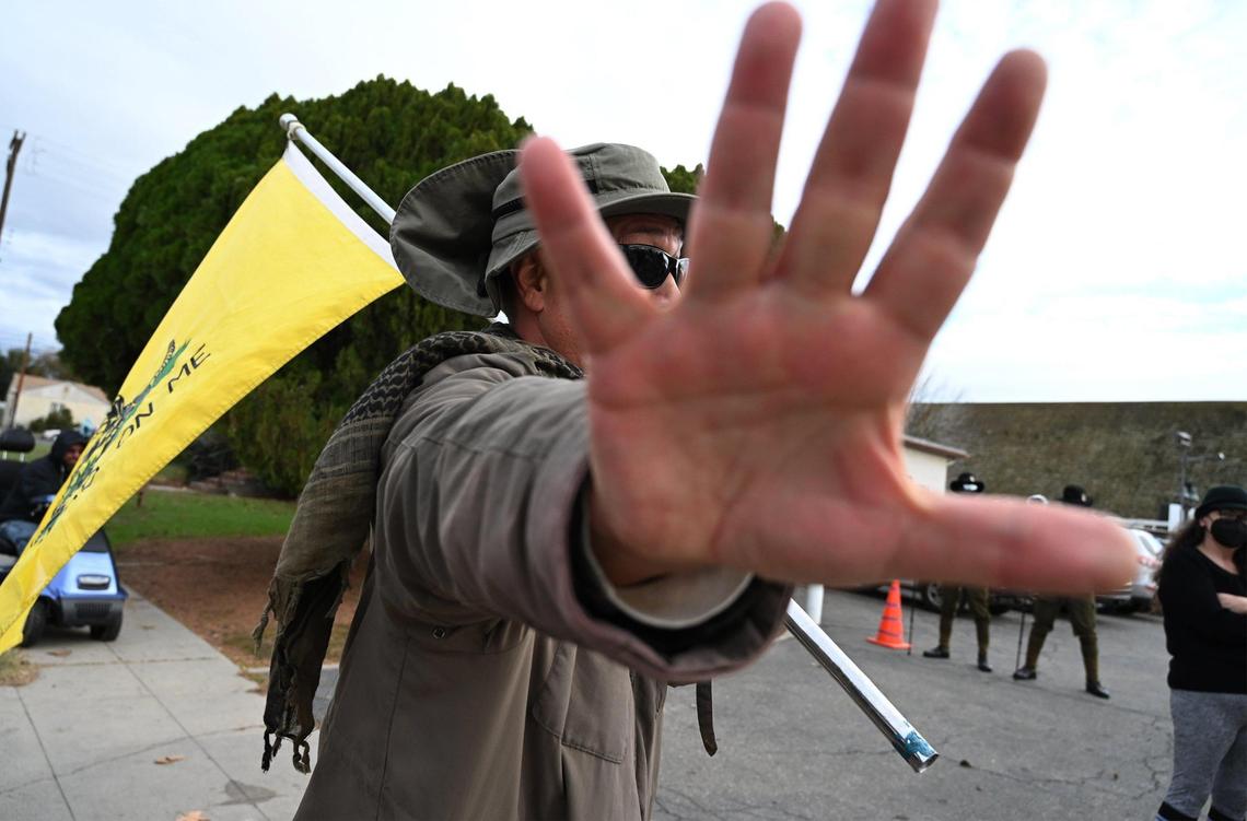 A protester against the Fresno Drag Fest being held at Our Saviour’s Lutheran Church holds his hand up to block the camera Saturday, Dec. 10, 2022 in Fresno.