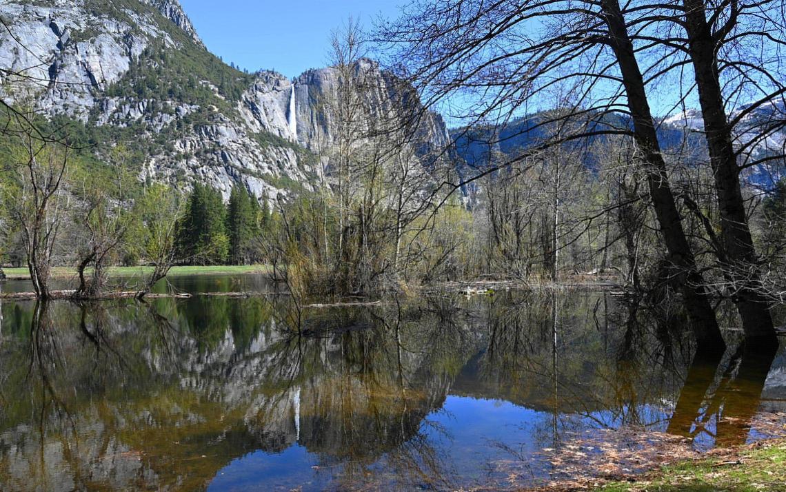 Upper Yosemite Fall is seen reflected in river overflow as park officials expect the Merced River to rise due to snow melt this weekend. Photographed Friday, April 28, 2023 in Yosemite Valley.