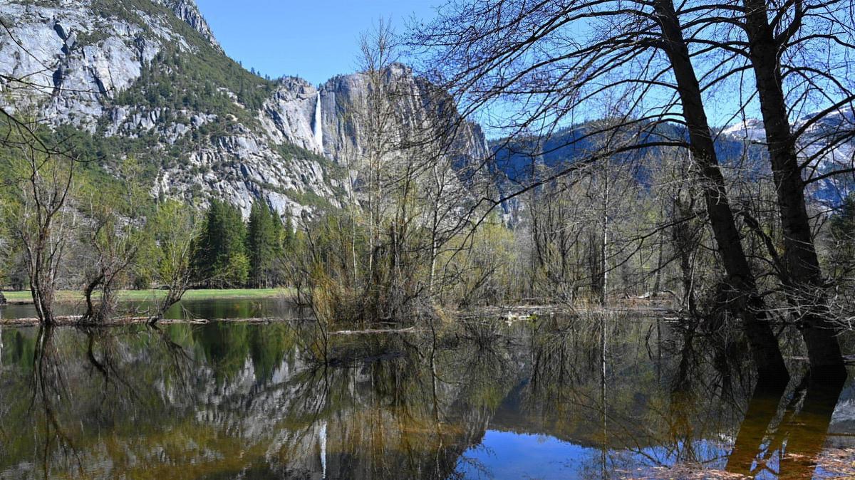 Upper Yosemite Fall is seen reflected in river overflow as park officials expect the Merced River to rise due to snow melt this weekend. Photographed Friday, April 28, 2023 in Yosemite Valley.