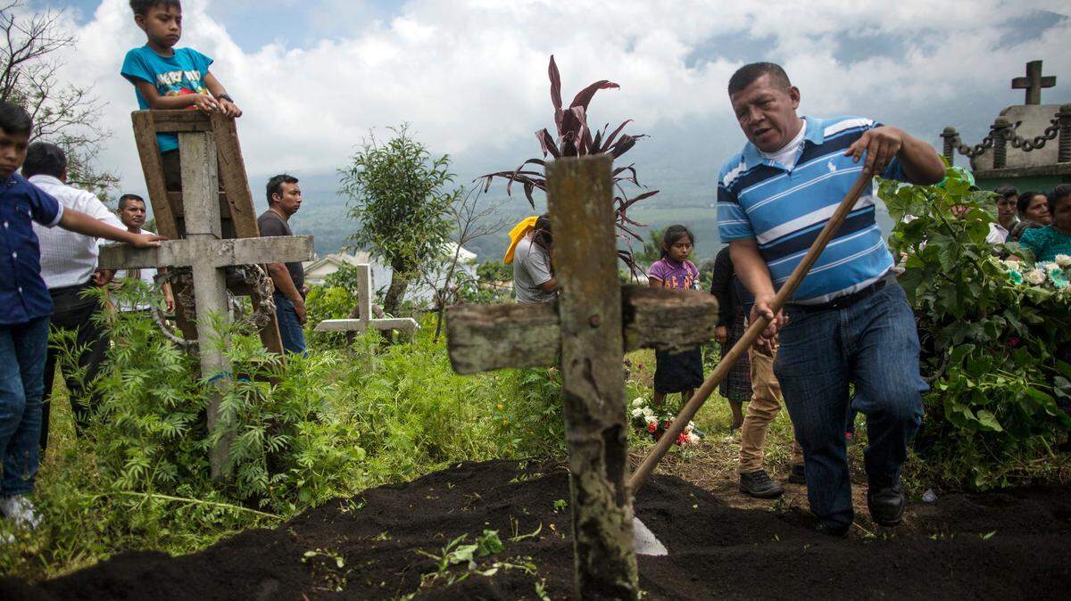 The body of 70-year-old Juan Toma Lopez killed by Guatemala's Volcano of Fire eruption is buried June 18, 2018.