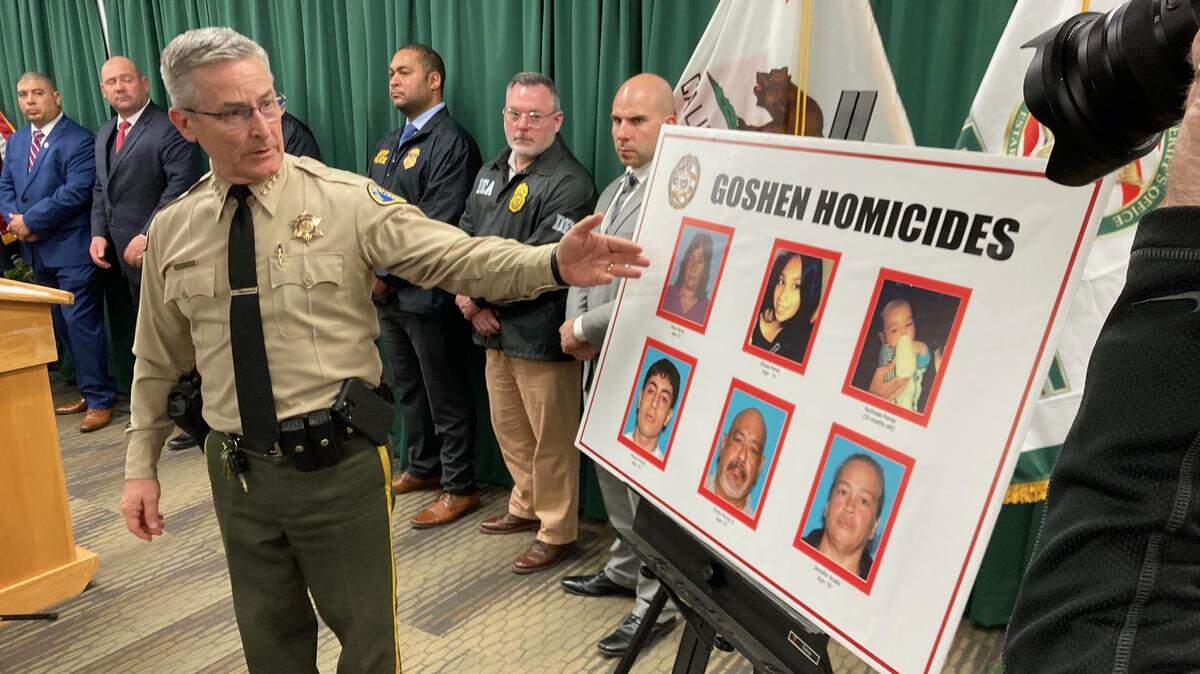 Tulare County Sheriff Sheriff Mike Boudreaux during a news conference in Visalia on Tuesday, Jan. 17, 2023, points to the victims of a mass shooting on Monday in Goshen: Eladio Parraz, 52; Marcos Parraz, 19; Jennifer Analla, 49; Rosa Parraz, 72; Elyssa Parraz, 16; and Nycholas Parraz, 10-months-old.