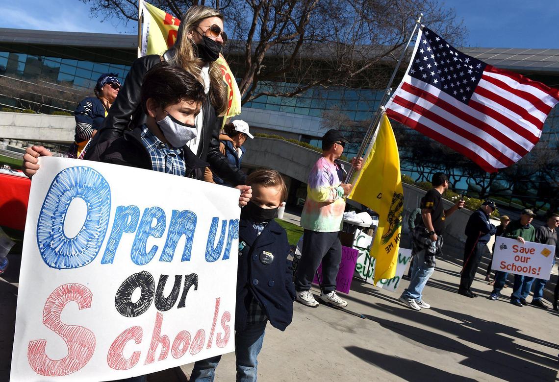 Lydia Valdez with her sons, Giovanni, 7, left, and Cristiano, right, 4, join in the Save Our Kids rally to promote reopening Fresno Unified schools amid the coronavirus pandemic Saturday, March 6, 2021, at Fresno City Hall. Both boys are in Fresno Unified.