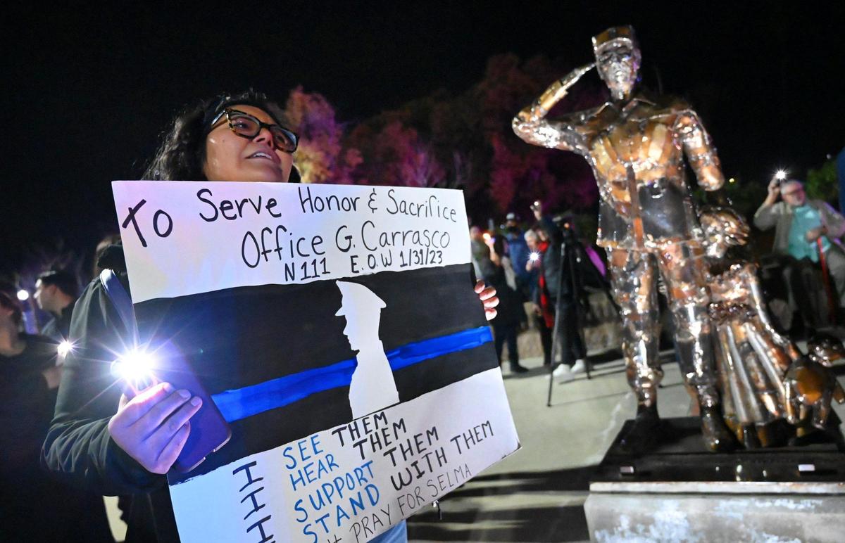 Consuelo Hernandez of Selma sings along with hundreds gathered for a vigil in Veterans Park for slain Selma officer Gonzalo Carrasco Jr. Thursday, Feb 2, 2023 in Selma.