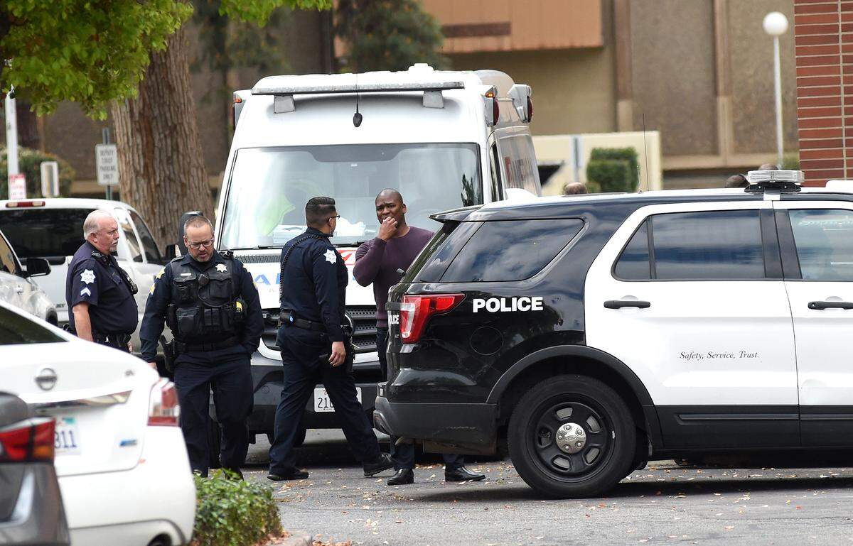 Fresno Police officers stand by during the investigation of an officer involved fatal shooting in the police annex building Tuesday morning, March 28.