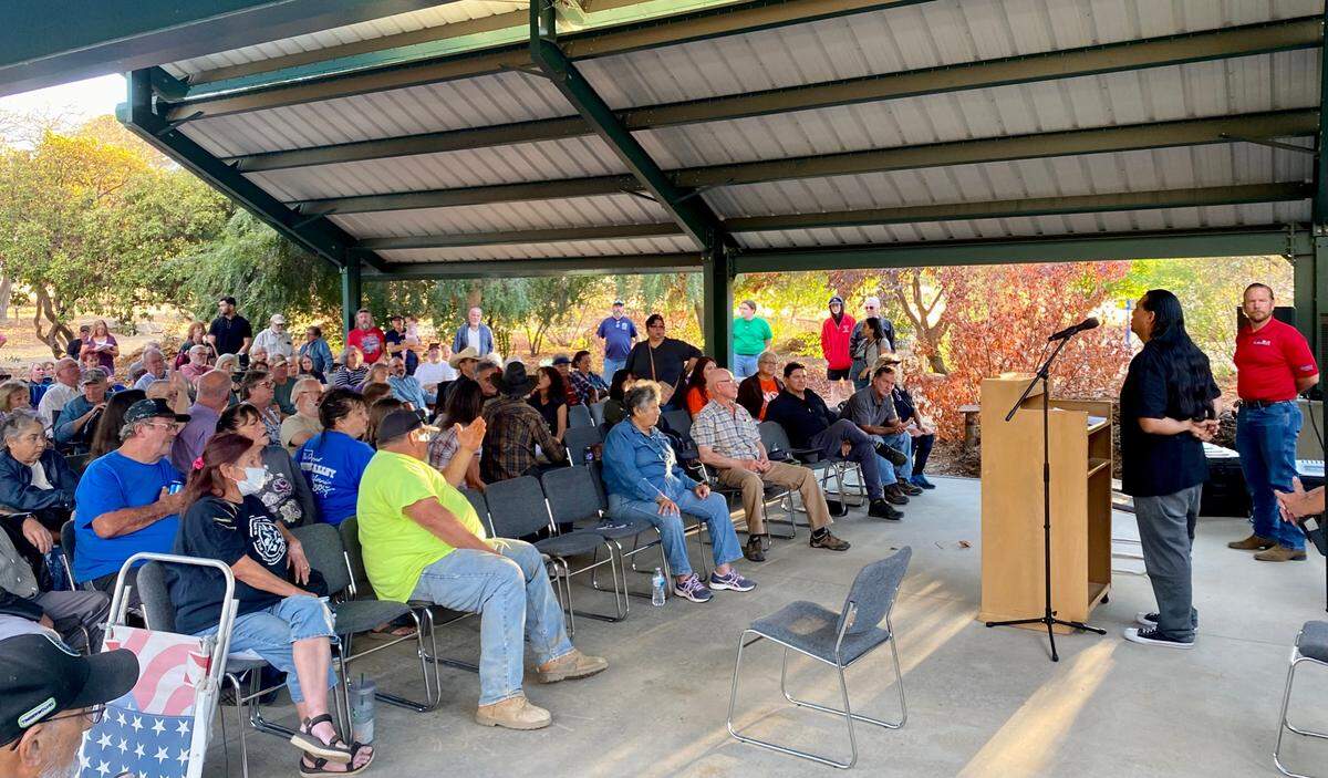 Roman Rain Tree speaks to a crowd in the Fresno County town of Squaw Valley, California, during a Sept. 20, 2022 meeting organized by Fresno County Supervisor Nathan Magsig, pictured at far right. Rain Tree started a campaign to change the town’s name two years ago.