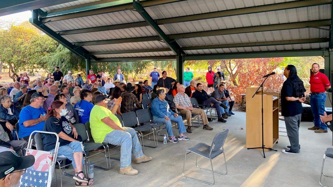Roman Rain Tree speaks to a crowd in the Fresno County town of Squaw Valley, California during a Sept. 20, 2022 meeting organized by Fresno County Supervisor Nathan Magsig, pictured at far right. Rain Tree started a campaign to change the town’s name two years ago.
