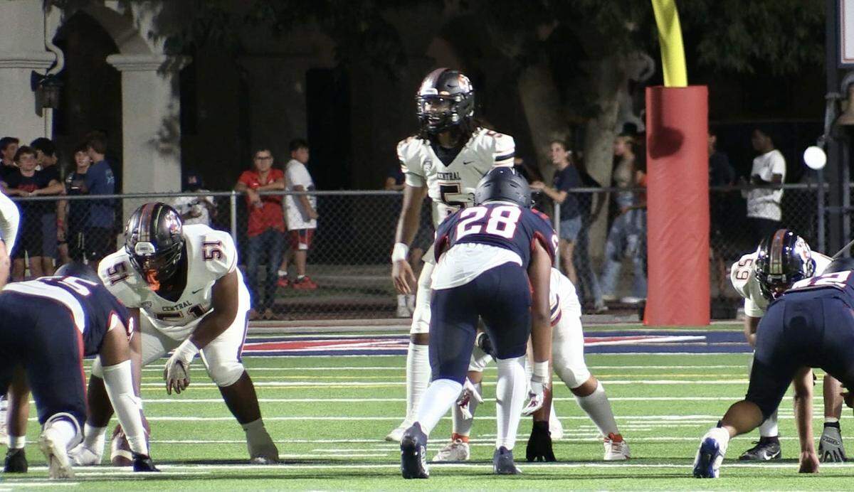 Central High quarterback Earl Riley takes a snap against San Joaquin Memorial on Friday, Aug. 25, 2023.