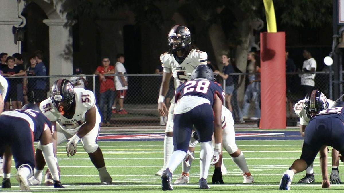 Central High quarterback Earl Riley takes a snap against San Joaquin Memorial on Friday, Aug. 25, 2023.