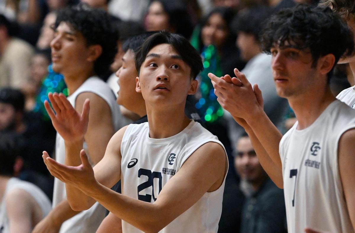 Clovis East’s Michael Yang, center, looks up to the scoreboard in the third set against Clovis High in the Central Section Division I volleyball championship Thursday, May 11, 2023 in Clovis.