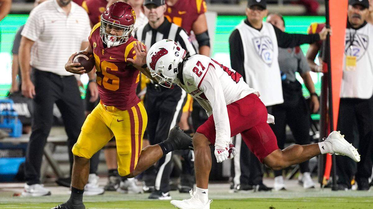 Southern California running back Travis Dye, left, fends off Fresno State defensive back LJ Early during the first half of an NCAA college football game Saturday, Sept. 17, 2022, in Los Angeles. (AP Photo/Mark J. Terrill)