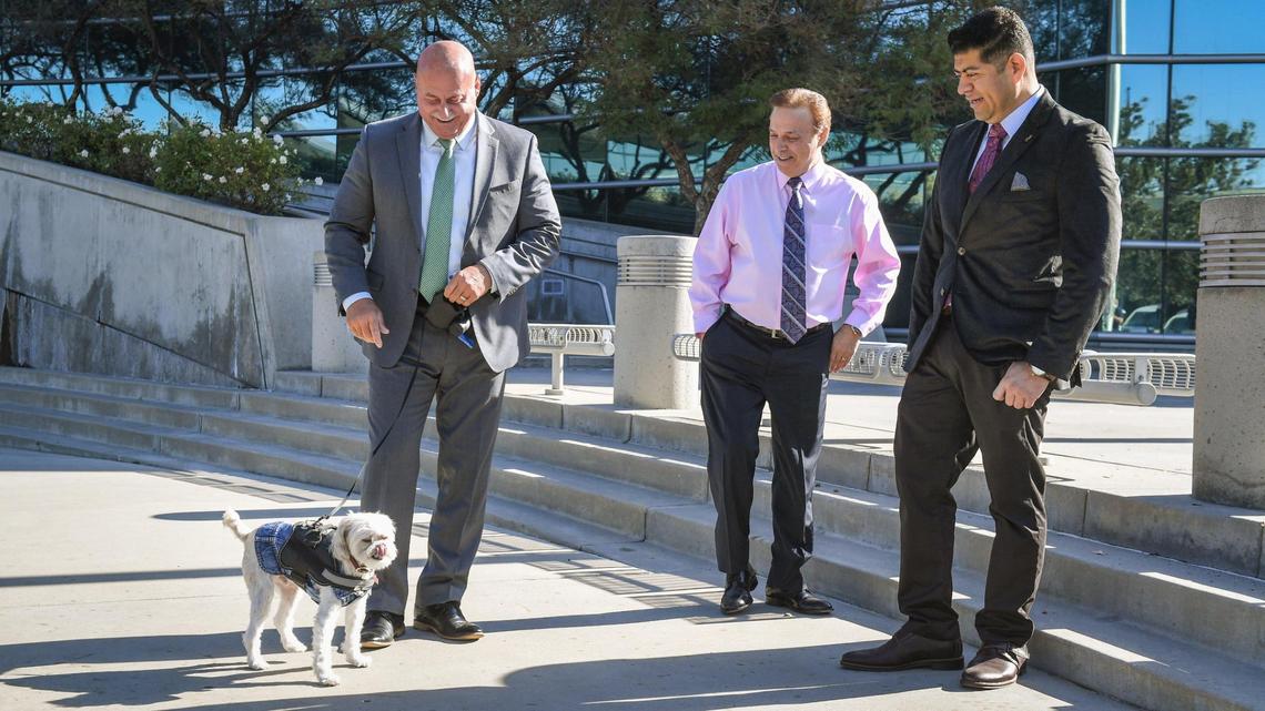 Fresno Mayor Jerry Dyer stands with his dog Stitch as City Councilmembers Garry Bredefeld, center, and Luis Chavez watch before holding a news conference to announce the establishment of an animal shelter donation account with the city of Fresno, outside Fresno City Hall on Wednesday, Oct. 13, 2021.