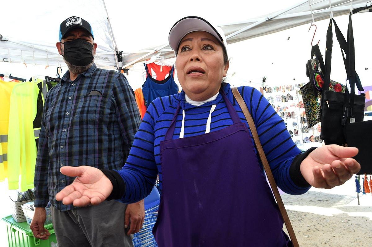 Street vendor Reina Acevedo, with husband Francisco Matias, talks about the the anxiety that has gripped the street vendor community in the aftermath of the the shooting death of vendor Lorenzo Perez. Local advocates fanned out on March 31 to make contact with street vendors, offering them pepper spray and advice on how to protect themselves.