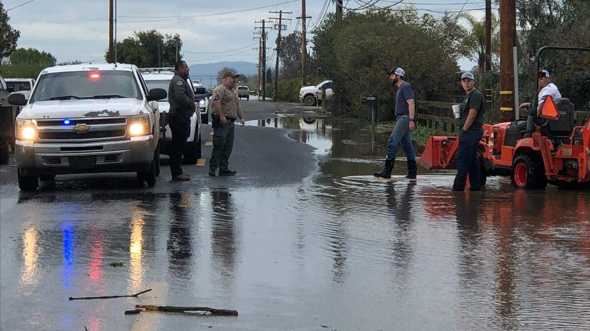 Tulare County Sheriff’s deputies talk to residents in an evacuation zone west of Porterville on Wednesday evening, March 15.
