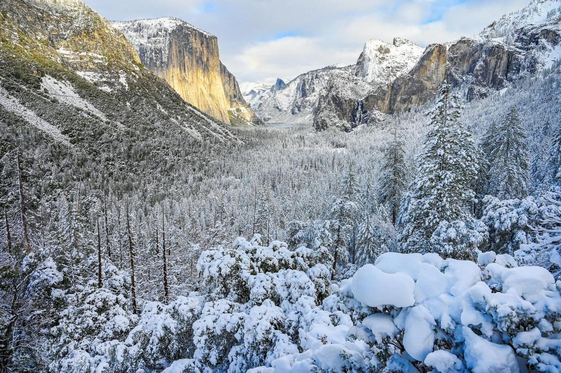 Snow covers the trees and cliffs in Yosemite Valley at Tunnel View in Yosemite on Wednesday, Dec. 15, 2021, following a snowstorm the day before.