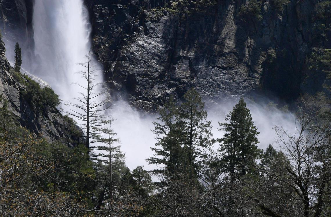 Bridalveil Fall’s mist is seen through the trees in April 2023 in Yosemite Valley. Warmer weather is melting the snow which feeds the waterfalls and rivers.