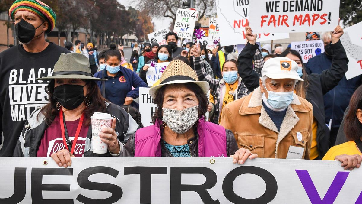 Civil rights activist Dolores Huerta, center, leads marchers Saturday, Dec. 4, 2021, through downtown Fresno toward the Fresno County Courthouse during a solidarity march to “demand fairness in California’s redistricting.”