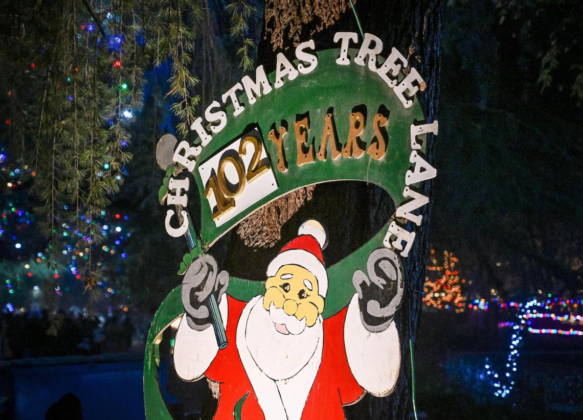 A sign shows Santa recognizing Christmas Tree Lane’s 102nd year on the first of two walk-only nights on Tuesday, Dec. 3, 2024.