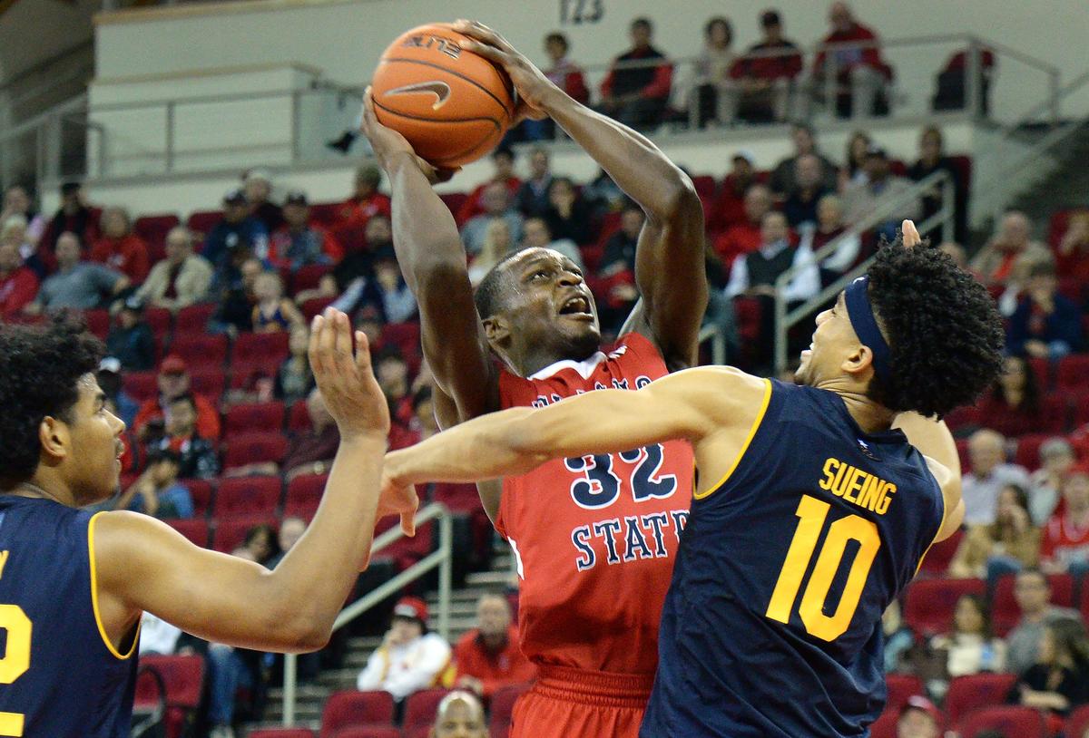 Fresno State forward Nate Grimes, center, puts up a shot between Cal’s Justice Sueing, right, and Andrew Kelly during the Bulldogs’ 95-73 victory over the Golden Bears at the Save Mart Center on Wednesday, Dec. 19, 2018.