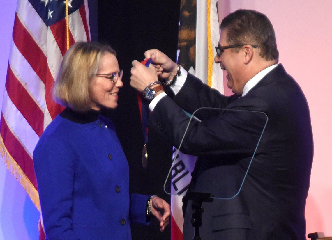 Fresno State President Joseph I. Castro awards the President’s Medal of Distinction to Joan Eaton, the highest non-degree award presented by Fresno State, at the fifth annual State of the University breakfast. Her mother, Virginia Eaton, though absent, was also awarded the medal, Tuesday, Feb. 11, 2020.