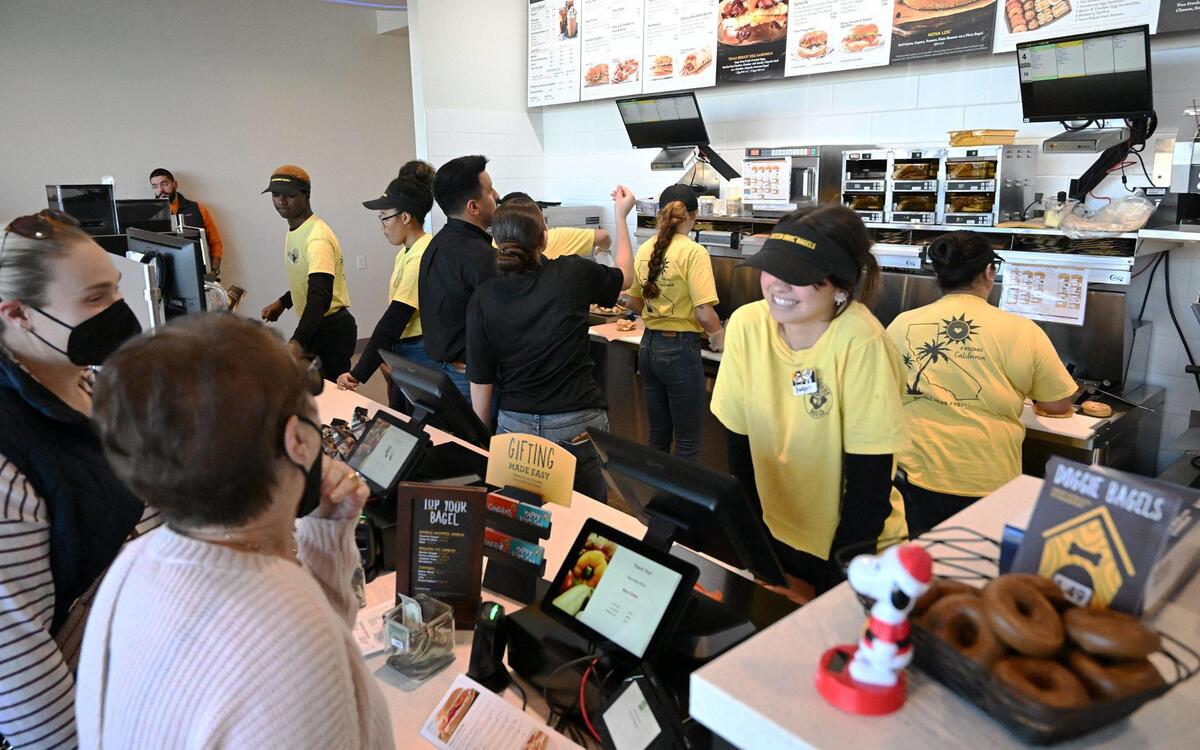 Customers order at Einstein Bros Bagels during its opening at Friant Road and Fresno Street Wednesday, Dec. 13, 2023 in north Fresno. The bagel shop offers freshly baked bagels, breakfast and lunch sandwiches, coffee and more.