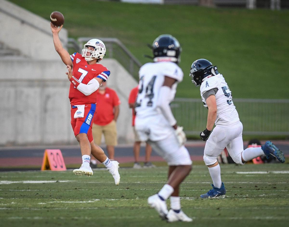 Buchanan quarterback Jayden Mandal, left, throws downfield against Bakersfield in their game at Veterans Memorial Stadium on Friday, Aug. 19, 2022.