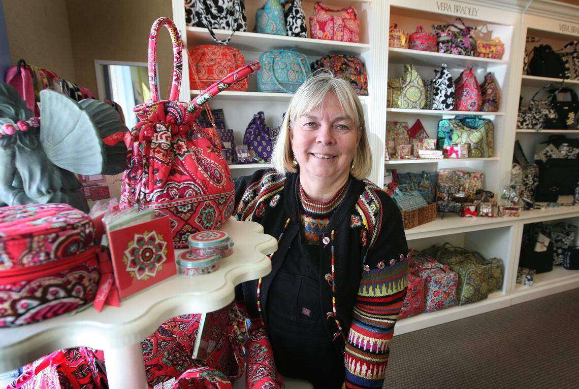 Jane Saunders, owner of Top Drawer, a store that specializes in Vera Bradley quilted handbags, stands at her shop in the Opus 1 shopping center at Bullard and Palm in this file photo. The store has closed, but she has opened two other smaller retail locations.