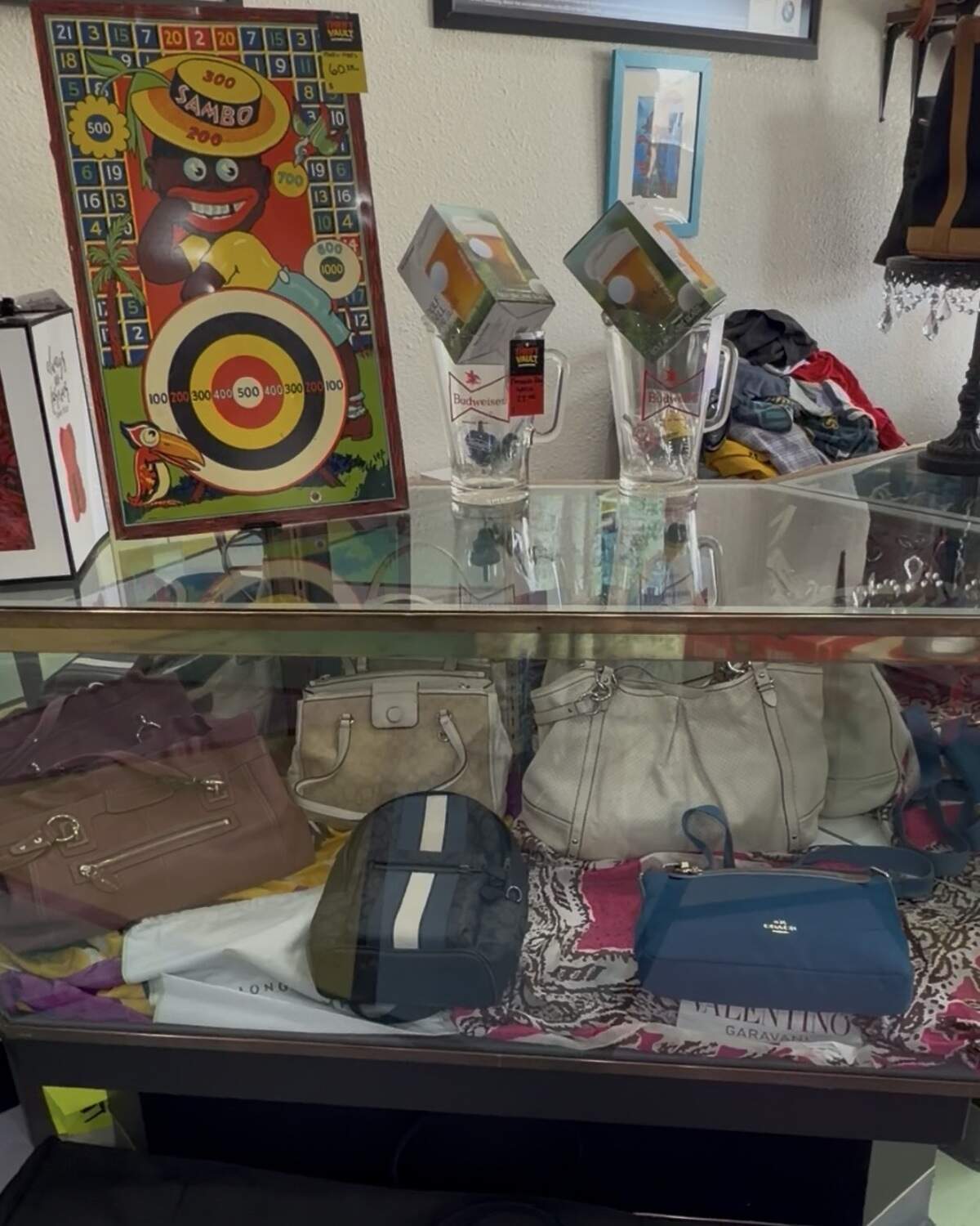 Bags are on display behind a glass case at The Thrift Vault.