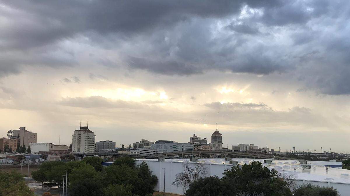 Threatening clouds loom over downtown Fresno early Tuesday morning.
