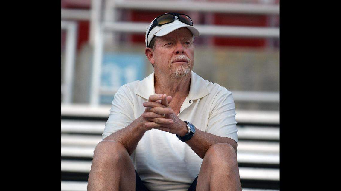 Former Fresno State football coach Pat Hill watches the first day of 2014 fall camp from the Bulldog Stadium bleachers.