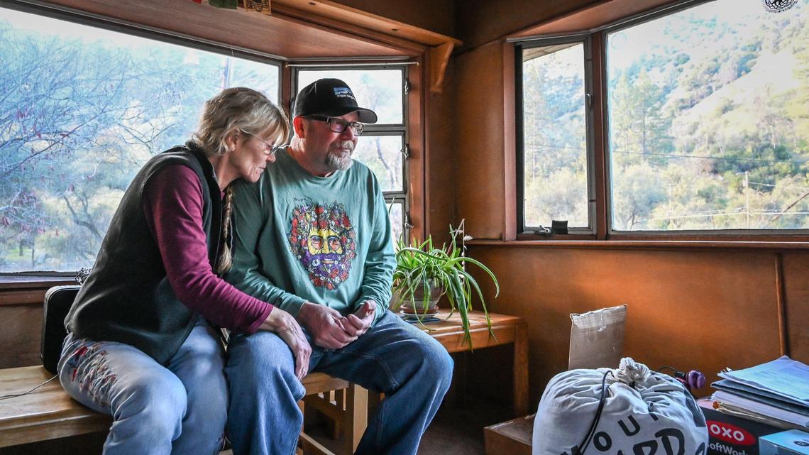 Longtime El Portal Trailer Park residents Neal and Nancy Dawson take a moment in their front room to take in the panoramic views of the surrounding canyon hills before moving out for good on Sunday, March 13, 2022.