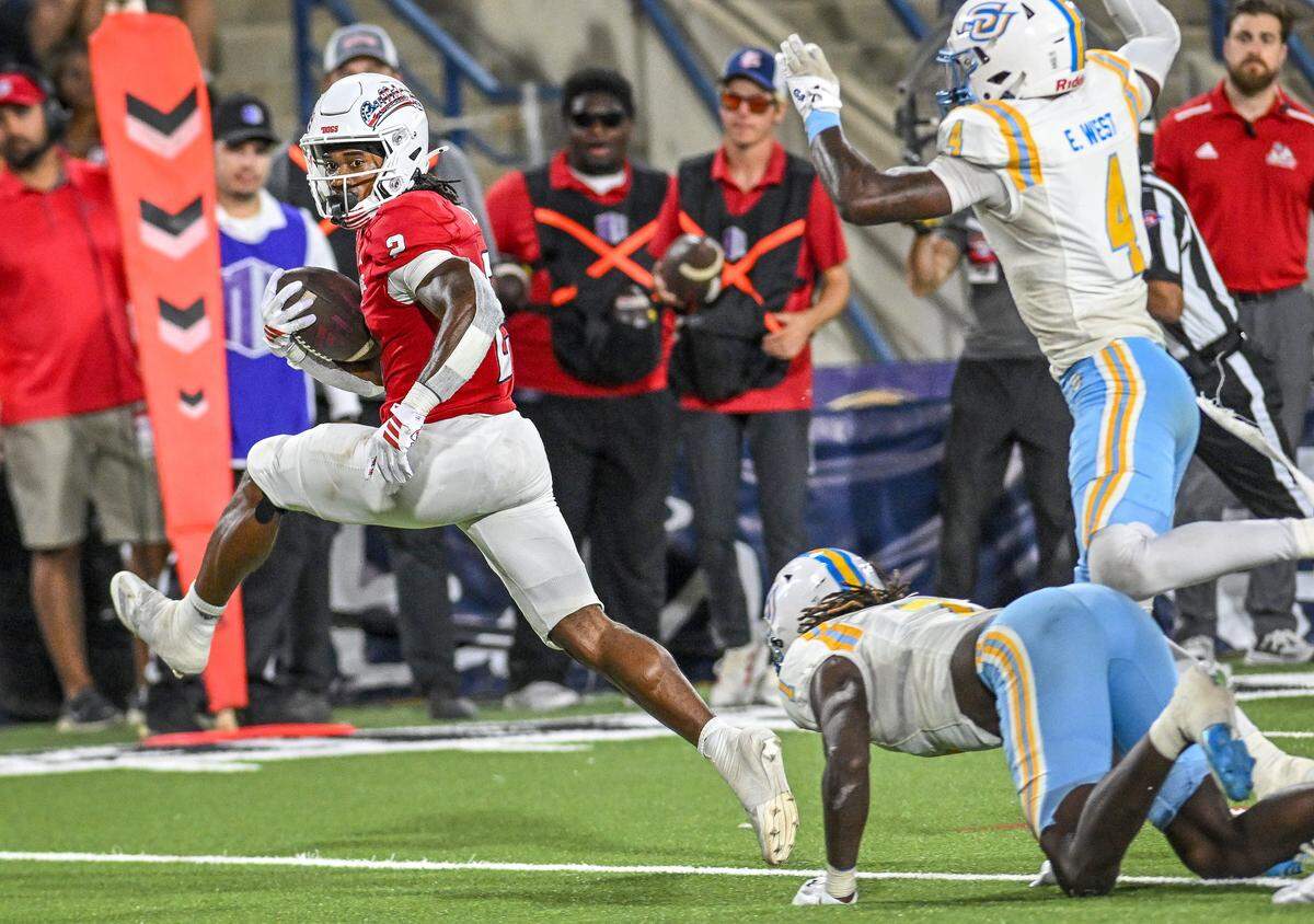 Fresno State's Rayshon Luke, left, jumps past a Southern University defender before getting into the end zone for a touchdown during their game at Valley Children's Stadium in Fresno on Saturday, Sept. 13, 2025. 