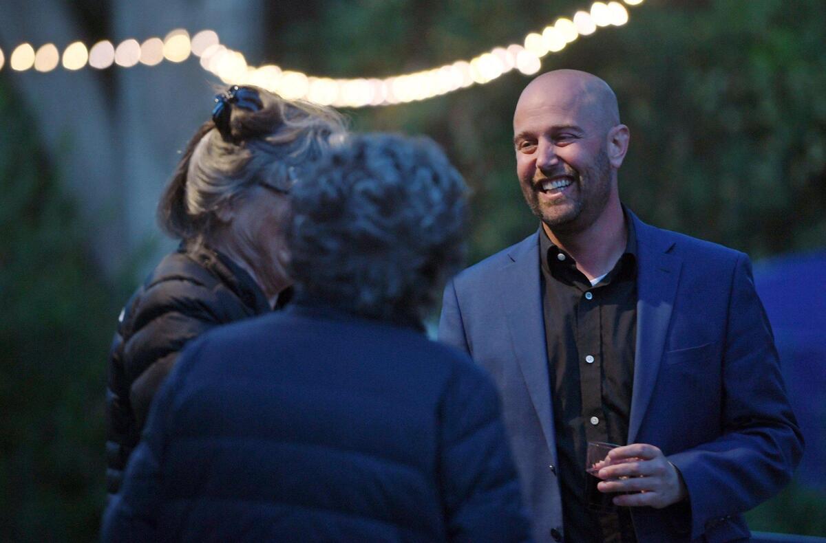 Andy Levine, right, candidate for Fresno Unified School Board, District 5, greets guests at his party on election night Tuesday, April 12, 2022 in Fresno.