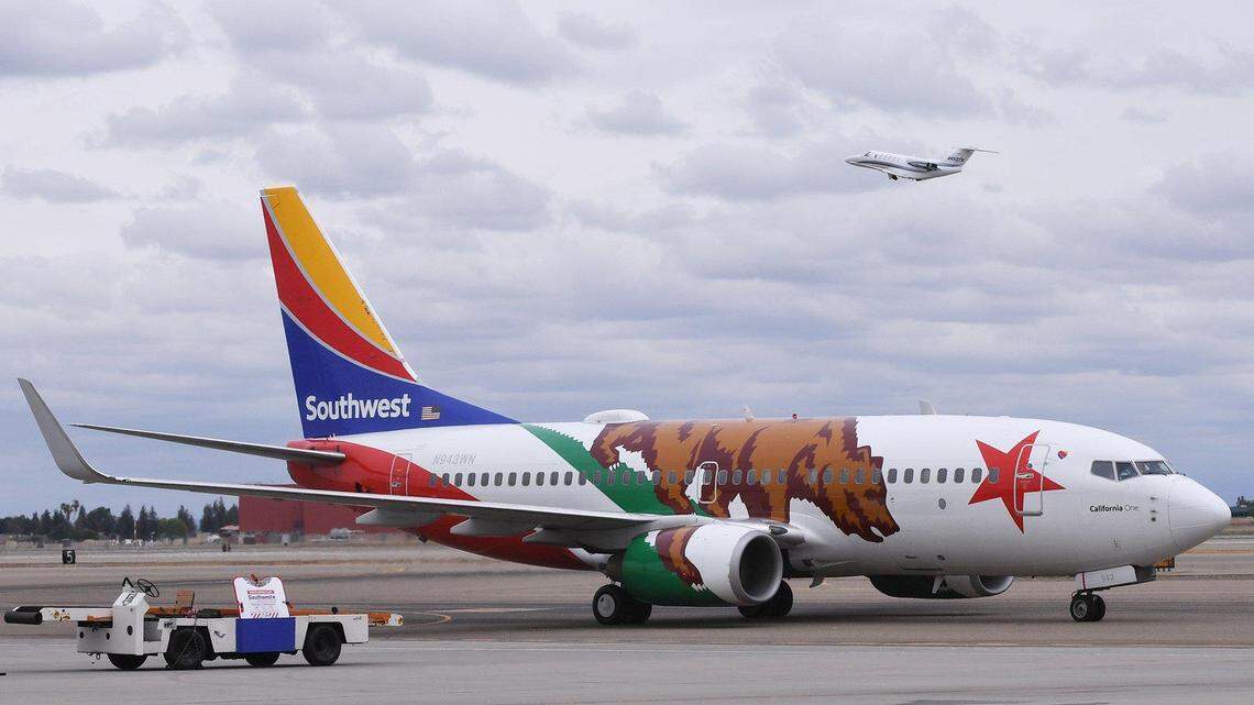 A small plane lifts off behind Southwest Airlines' 737 'California One' as it prepares to leave on its inaugural flight leaving Fresno Yosemite International Airport for Las Vegas Sunday morning, April 25, 2021 in Fresno.