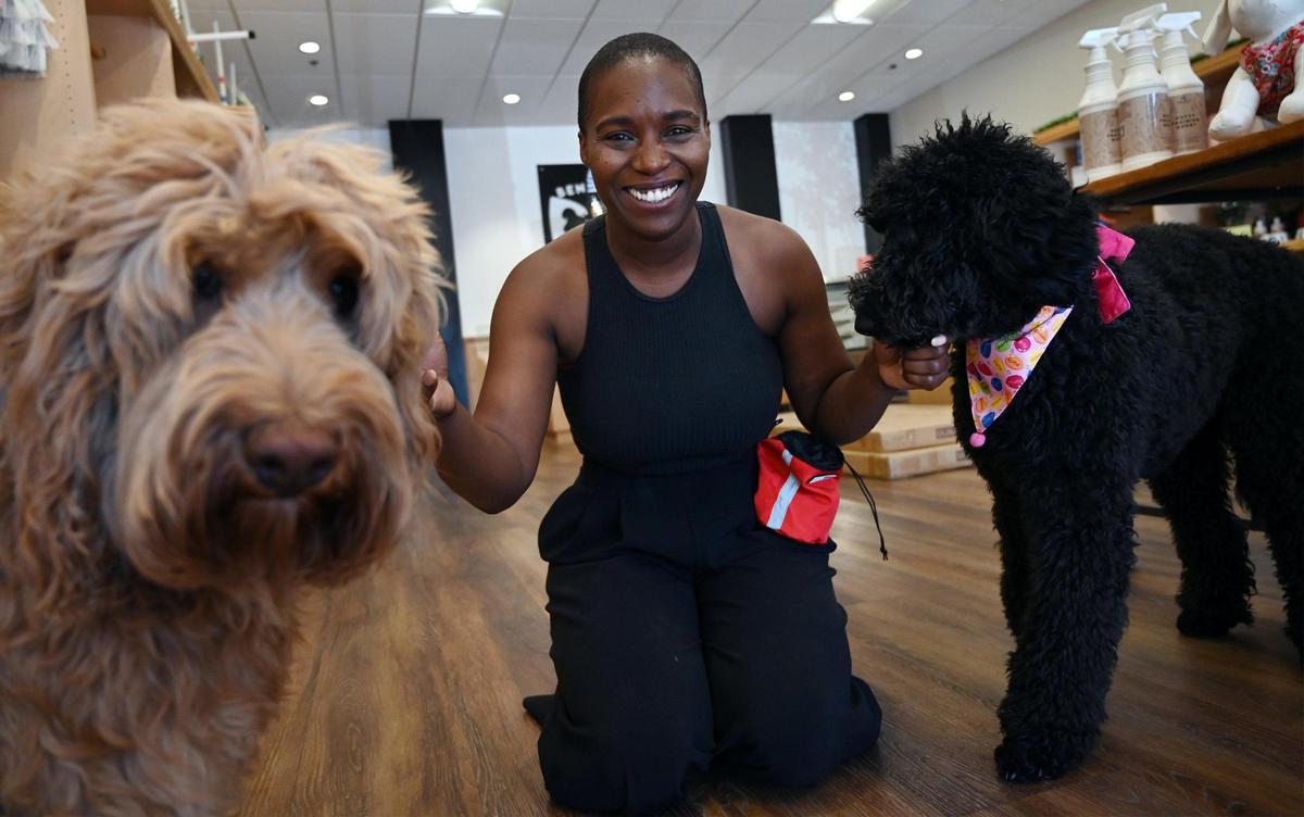 Ebony Brown, with her dogs Bentley, left, and Beignet, right, at her new shop Bentley’s Barkery & Barktique located in Fig Garden Village. Photographed Wednesday, Aug.10, 2022 in Fresno.