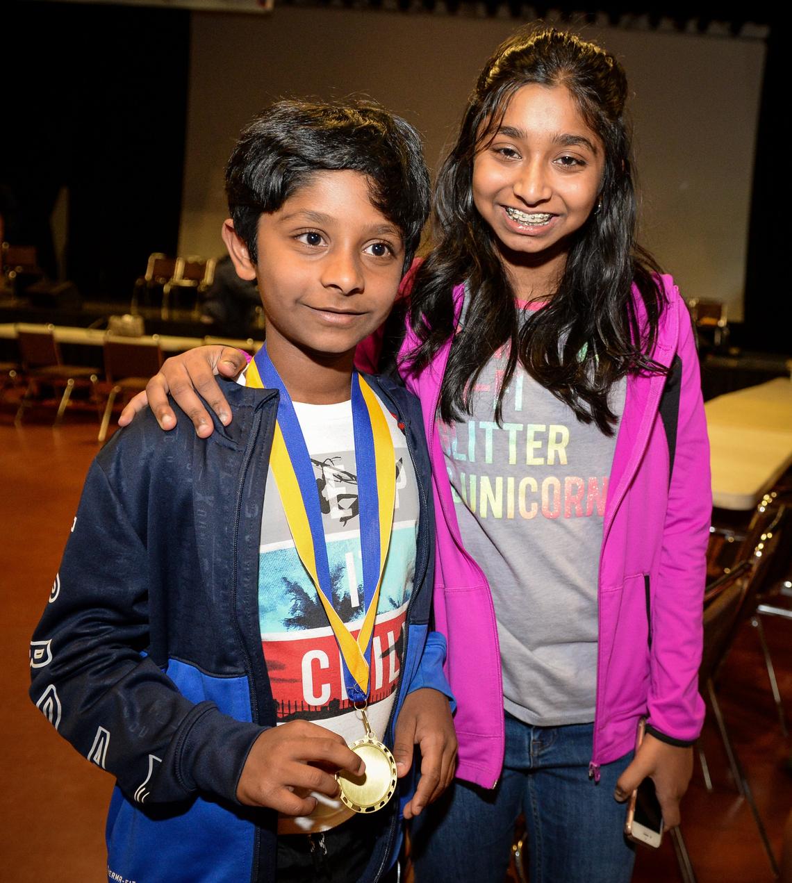 Fugman Elementary School student Achuth Vinay stands with his sister, former National Spelling Bee winner Ananya Vinay, after winning the the Scripps Oral Spelling Bee at the 25th annual Fresno County Spell Off at the Fresno State Satellite Student Union on Tuesday, March 19, 2019.