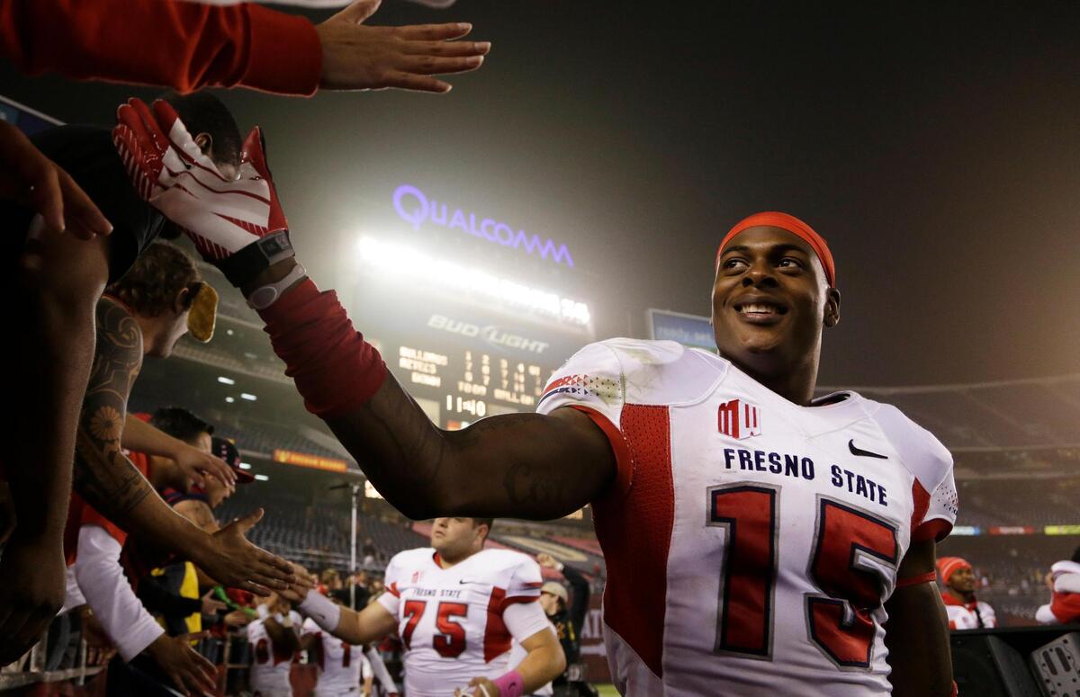 Former Fresno State wide receiver Davante Adams, right, is greeted by fans after a victory at San Diego State in 2013. Adams caught a school-record 233 passes in two seasons, a mark that the Bulldogs’ KeeSean Johnson could break against the Hawaii Rainbow Warriors on Saturday, Oct. 27, 2018. Johnson is eight receptions away.